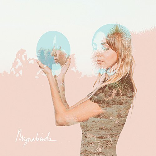 Woman with blurred, mirrored images of her face and foliage.