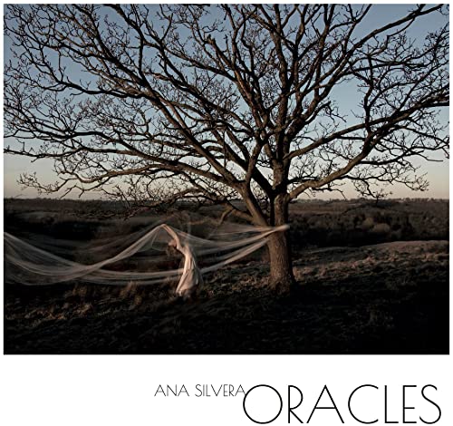CD cover: woman in white fabric beneath a bare tree.