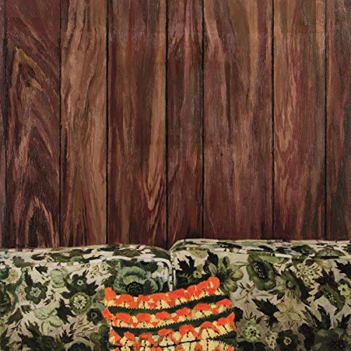 CD cover with a wood panel background and floral patterned cushion.