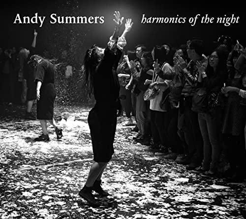 Black and white album cover featuring a crowd and a central figure with raised arms.