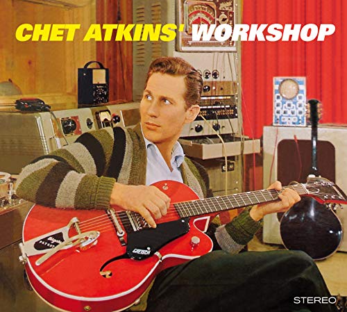 Chet Atkins playing a red Gretsch guitar in a recording studio.