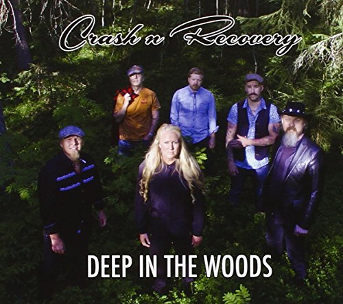 Six people in casual wear pose in a dense, green forest.