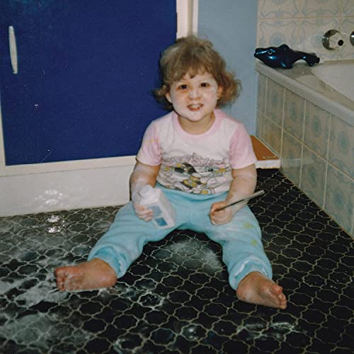 Vinyl record cover featuring a young child sitting on a bathroom floor.