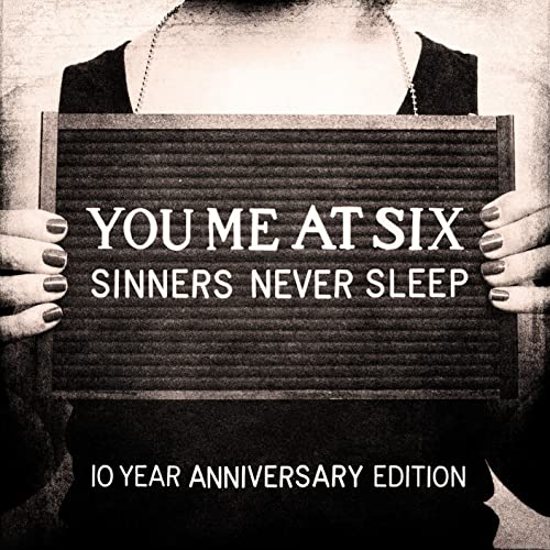Album cover for You Me At Six's "Sinners Never Sleep" with text on a board.