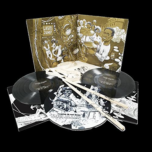 Two vinyl records, drumsticks, and open album artwork with illustrated figures.