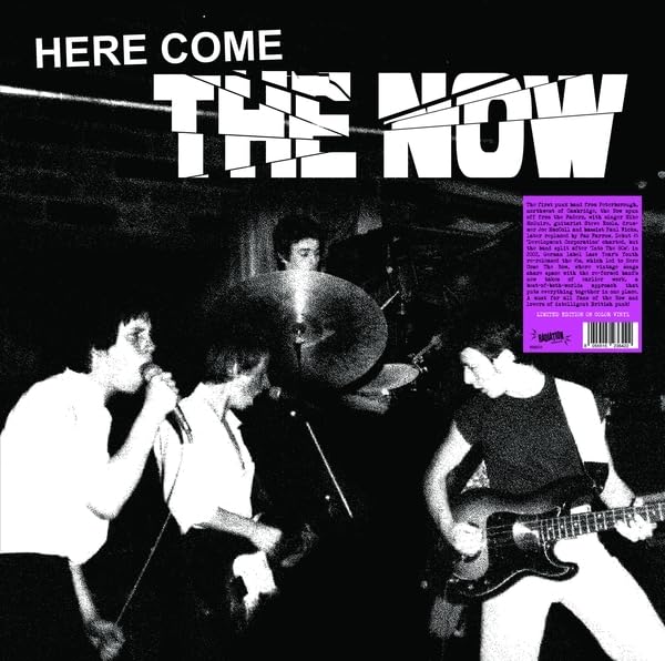 Black and white band photo with purple text: "Here Come The Now" vinyl.