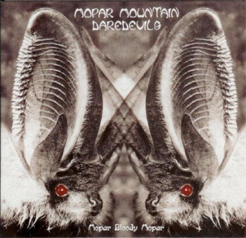 Record album cover featuring mirrored ram horns and red eyes.
