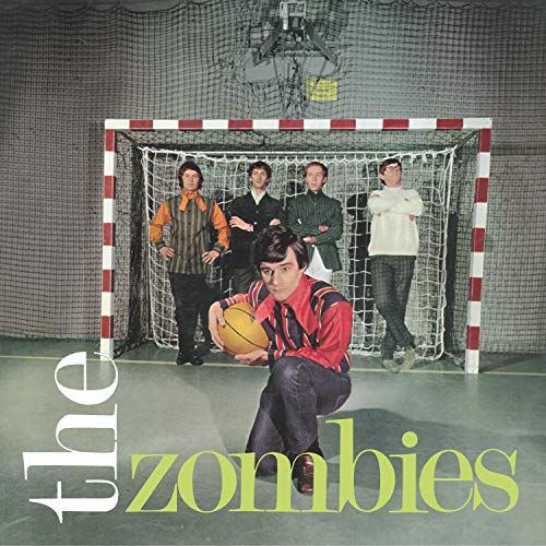 The Zombies band posing with a soccer ball in front of a goal.