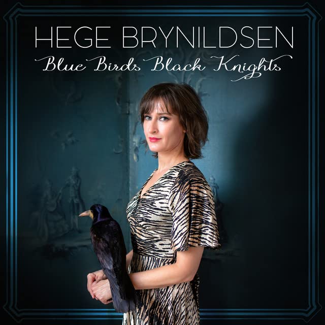 Album cover: woman with a black bird, ornate blue background.