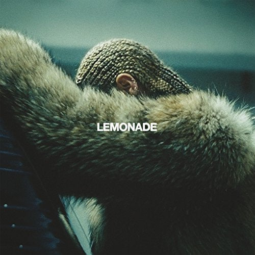 Beyoncé with braided hair leaning against a fur coat with Lemonade text overlay.