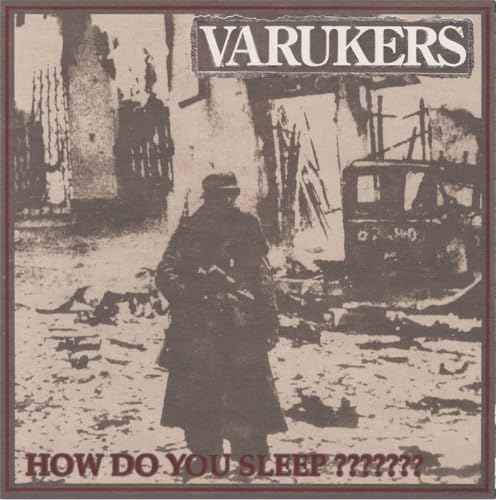 Black and white album cover featuring a figure in a ruined cityscape.