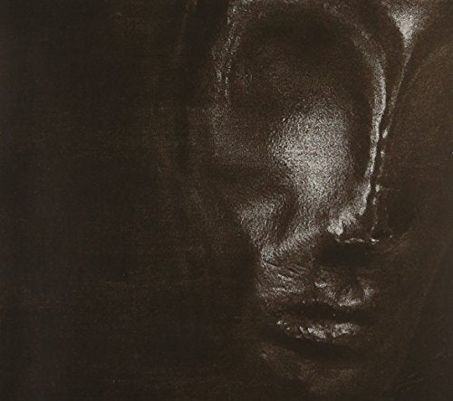 Dark, textured close-up of a face with closed eyes, CD cover art.