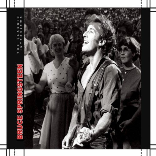 Black and white photo of Bruce Springsteen performing to a crowd.