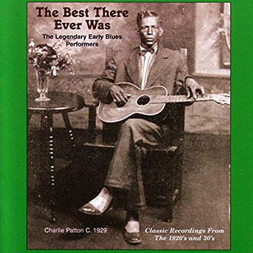 Black and white photo of Charlie Patton with a guitar, CD cover.