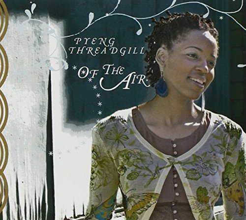 CD cover featuring a smiling Black woman with dreadlocks and floral clothing.
