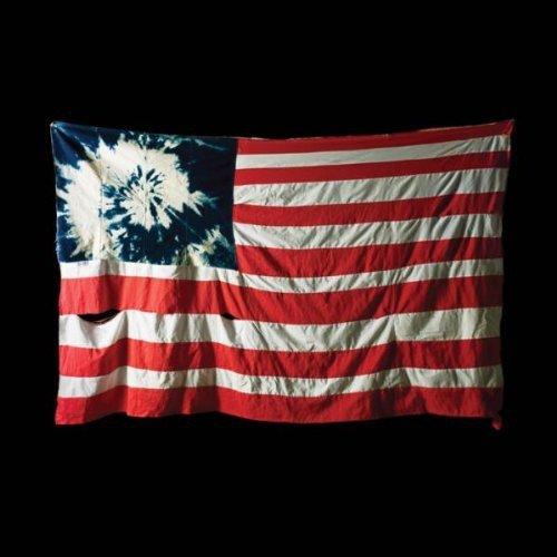Distressed tie-dye American flag against a black background.