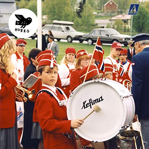 Youth marching band in red uniforms with instruments, Norway.