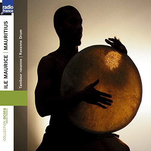 CD cover featuring a silhouetted man holding a large, round drum.