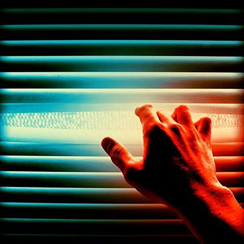 Hand reaching through blinds with blue and red light.
