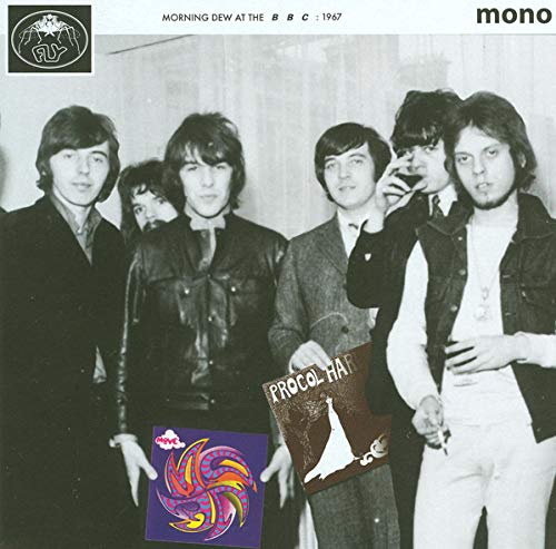 Black and white photo of Procol Harum, holding an album, on record sleeve.