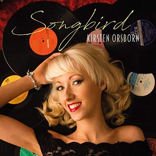 CD cover featuring blonde woman and stacked vinyl records, titled "Songbird.