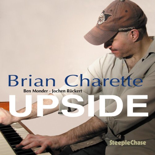 CD cover featuring a man with a hat playing a piano.