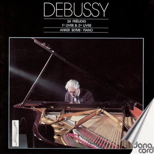 CD cover: pianist at a grand piano, dark background, text "Debussy".