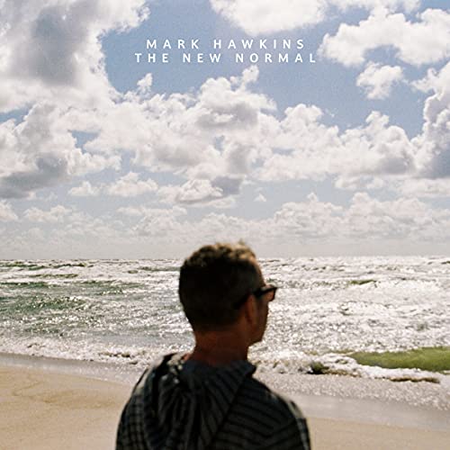 CD cover: man on beach under cloudy sky, album title visible.