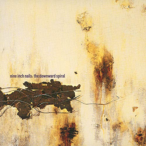 Album cover for Nine Inch Nails The Downward Spiral featuring abstract rusted metal textures.