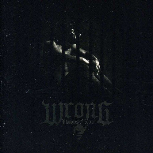 Dark album cover featuring a shadowed figure and band name "Wrong".