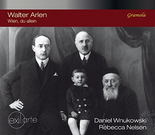 Black and white portrait of four people, including a child and elderly man.