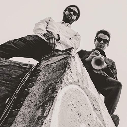 Black and white photo of two musicians with brass instruments.