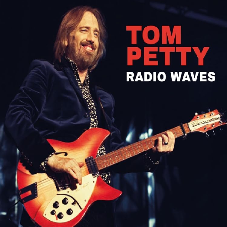 Tom Petty playing a red electric guitar, album cover for "Radio Waves.