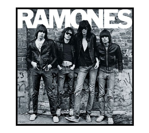 Black and white photo of The Ramones band members posing against a brick wall.