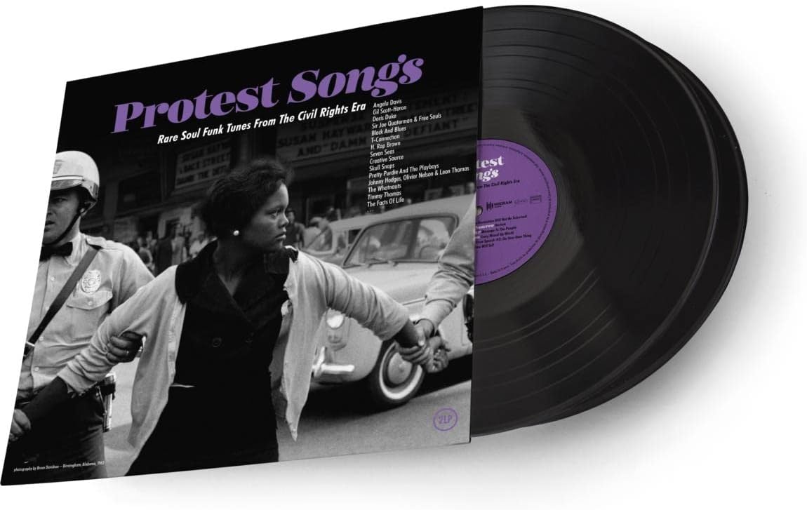 Protest Songs" vinyl record cover with a black and white photograph of protestors.
