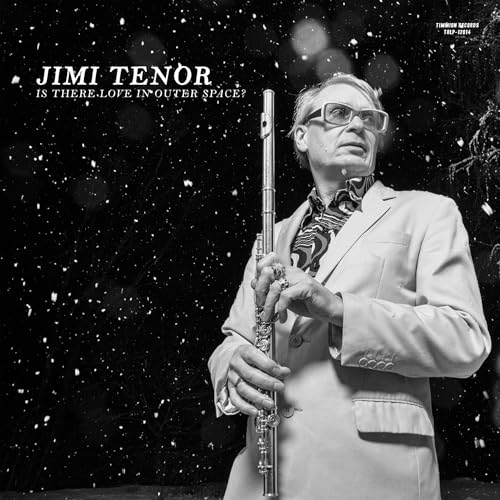 Jimi Tenor in suit and glasses holds a flute against a starry background.