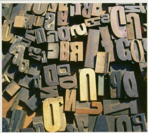 Close-up of scattered, vintage metal letterpress type blocks.