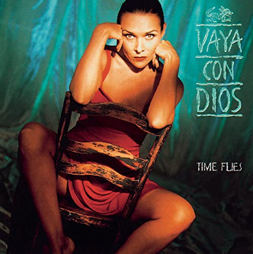 Album cover for Vaya Con Diosā āTime Fliesā featuring a woman seated.