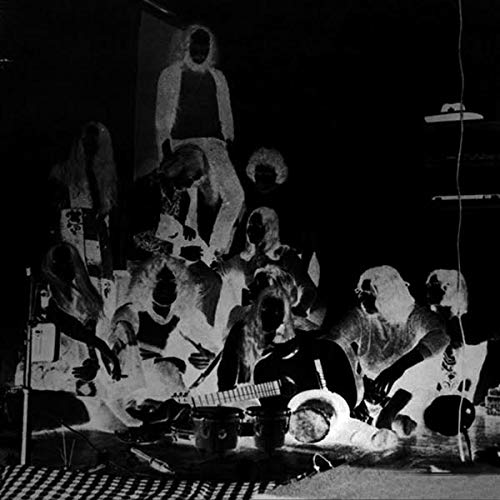 Black and white photo of hooded figures with musical instruments.