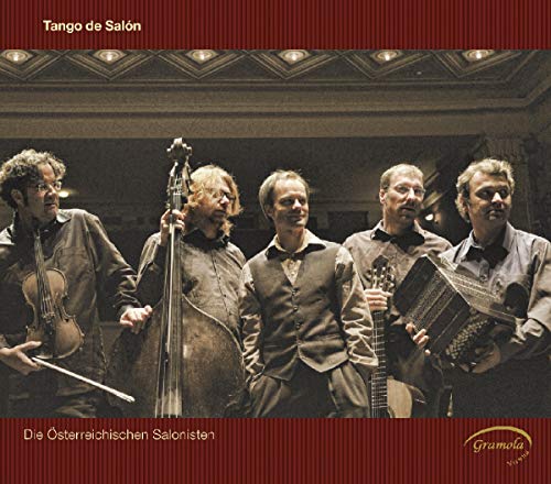 Five musicians with stringed instruments in a dimly lit room.