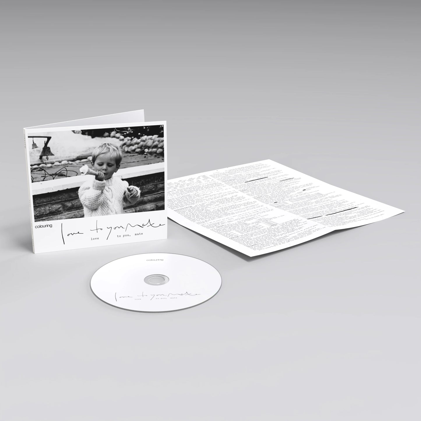 Black and white CD case with a child’s photo, disc, and insert.