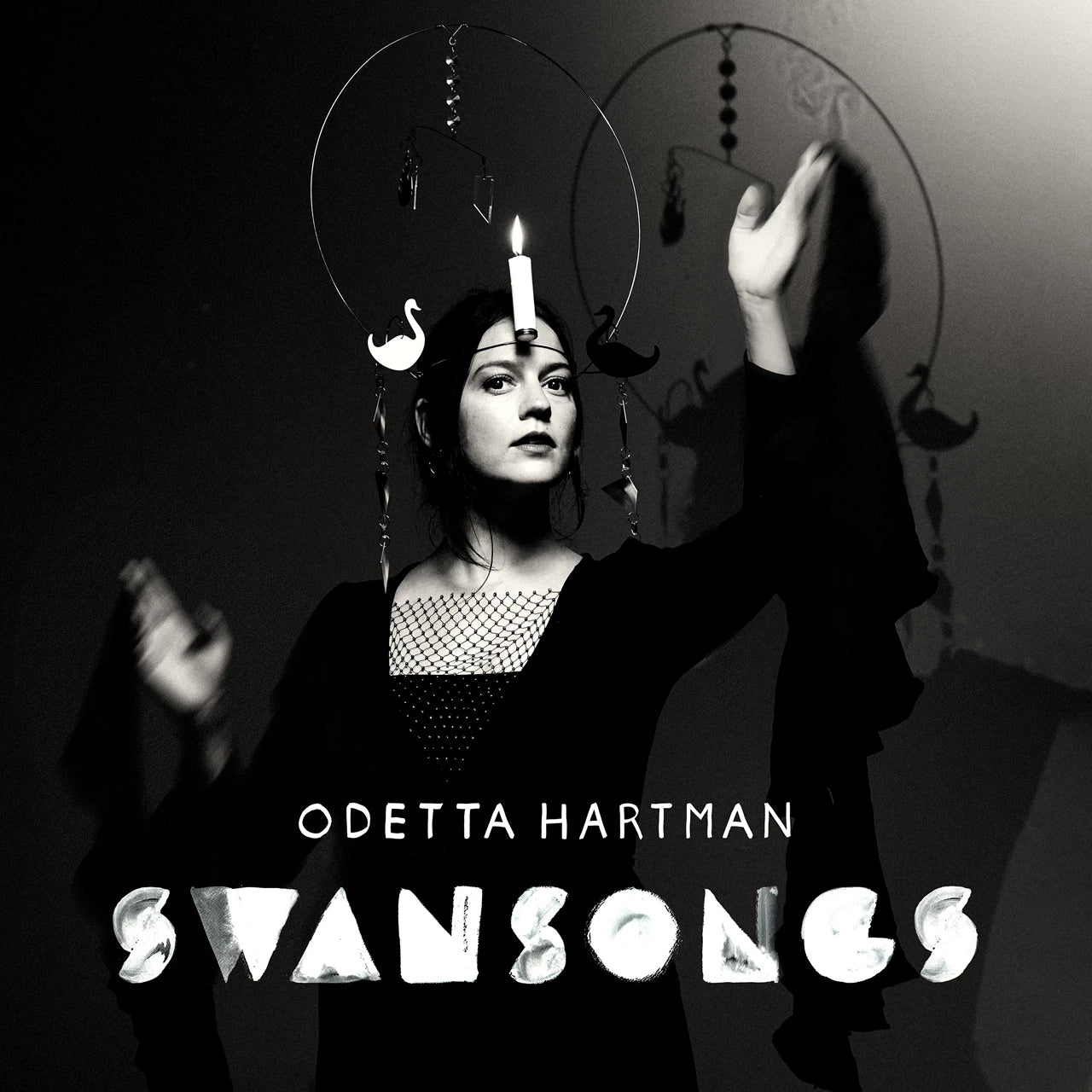 Black and white album cover for Odetta Hartman’s “Swansongs” featuring a woman and swans.