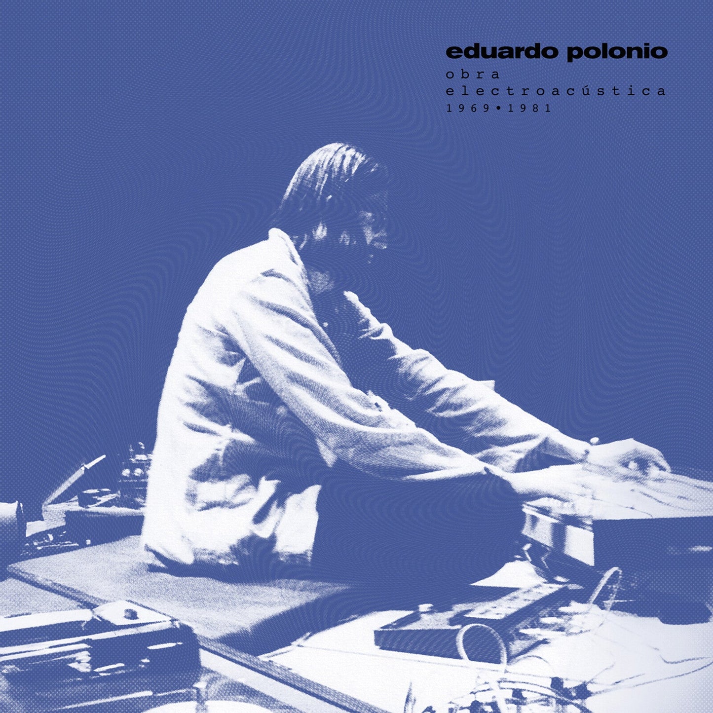Vinyl album cover featuring a man working with electronic equipment.