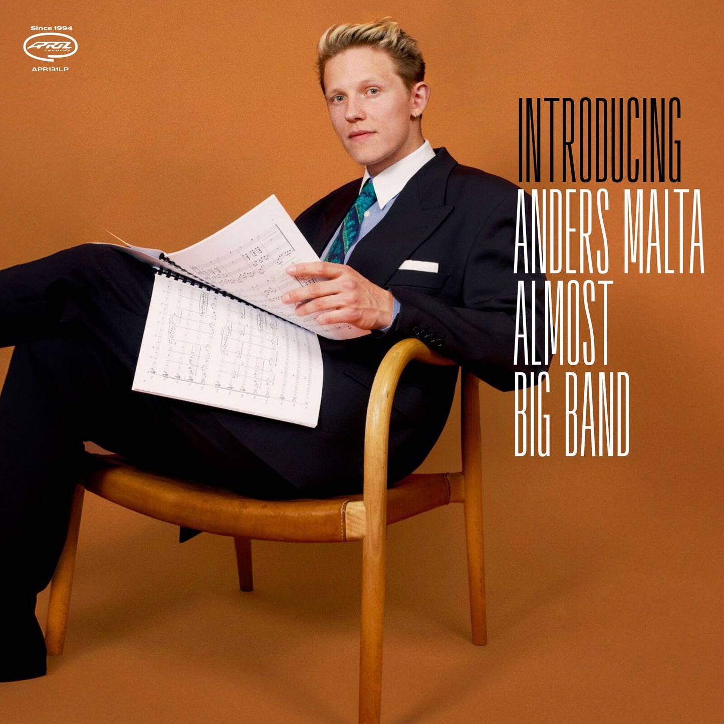 Man in suit seated with sheet music, album cover for Anders Malta.