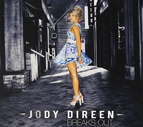 CD cover featuring a woman in a patterned dress standing in an alley.