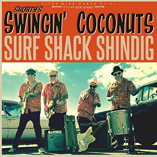 Four musicians in Hawaiian shirts playing guitars and drums outdoors.