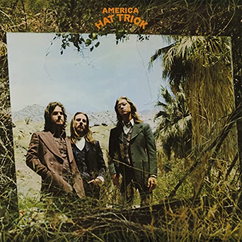 Album cover for America’s “Hat Trick” featuring three men in a desert landscape.