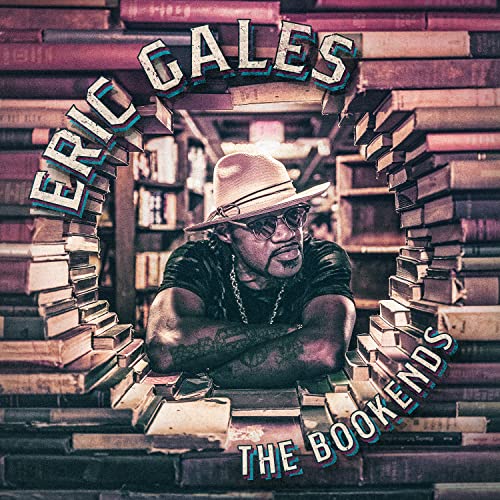 Eric Gales album cover featuring a man in a hat framed by books.