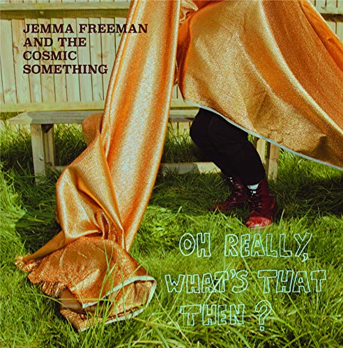 Album cover featuring a person draped in gold fabric on green grass.