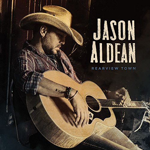 Man in cowboy hat playing guitar with album title and artist name beside him.